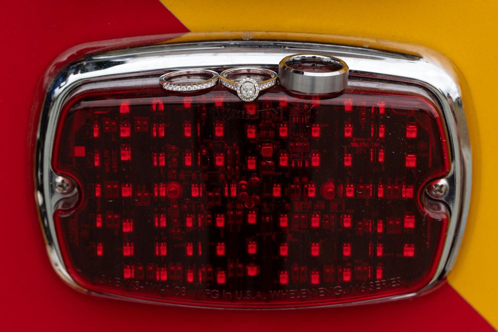 Vintage red tail light with chrome trim showing detailed grid pattern.