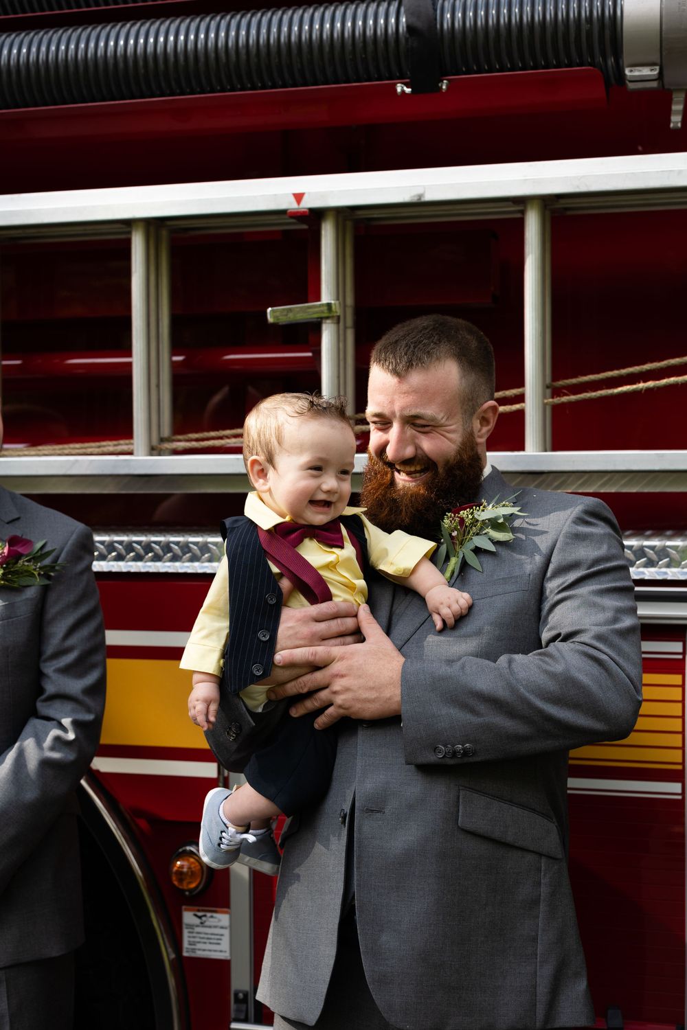 Sweet moment shared in front of fire truck during wedding celebrations.