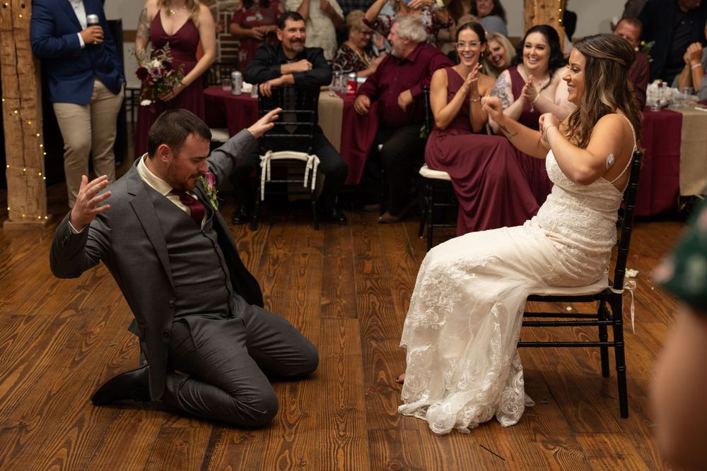 Wedding entertainment moment with guests seated on chairs during a reception game or activity.