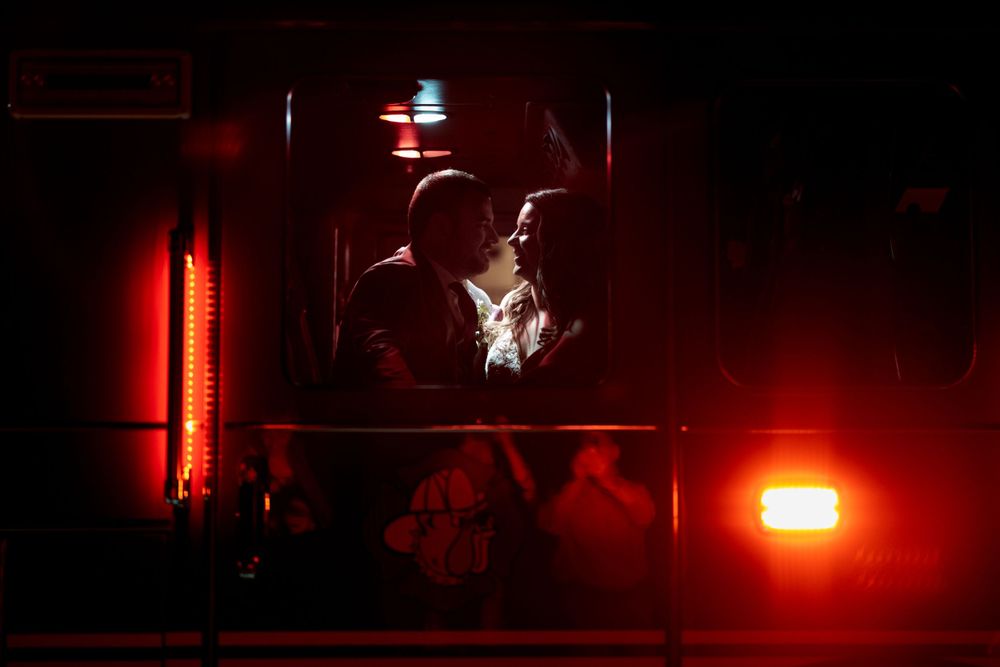 Dramatic silhouette of dancers illuminated by red stage lighting creates a romantic atmosphere.