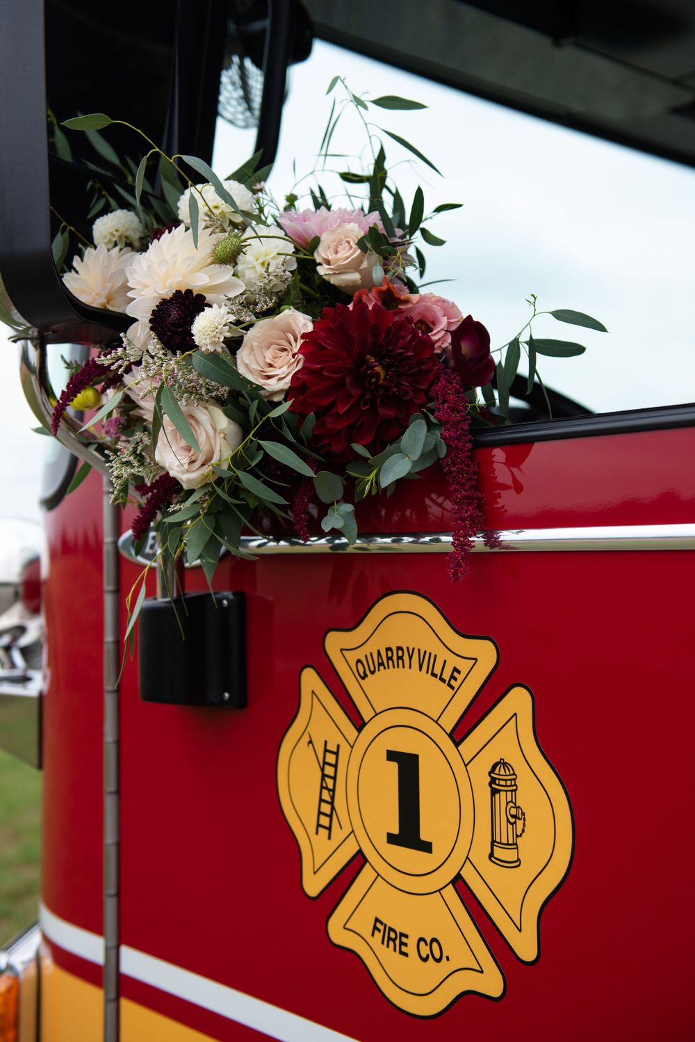 Beautiful floral arrangement with burgundy and pink roses adorns a Quarryville Fire Company truck.