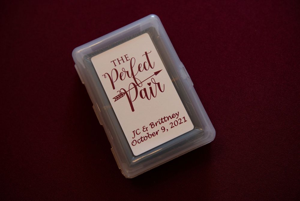Save the date card with elegant script typography photographed against dark background.