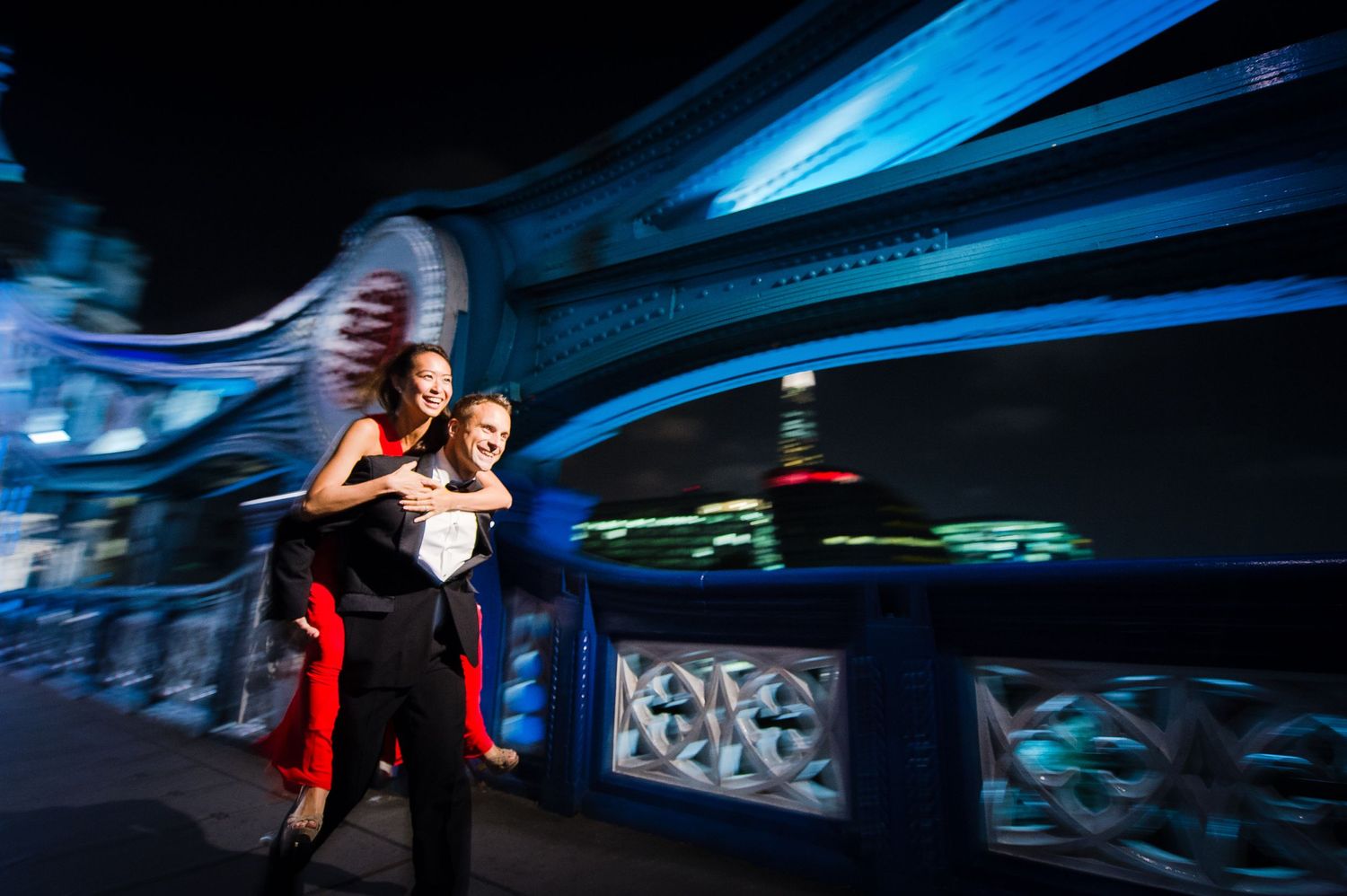 Pre-wedding in London, as bride laughingly is carried by groom