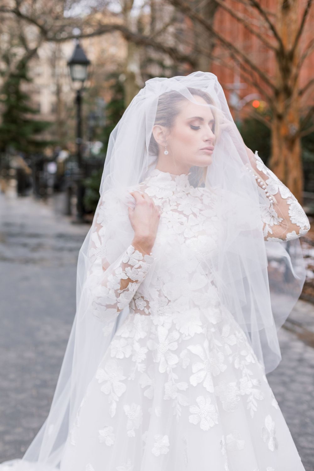 Ethereal bridal portrait featuring a floral applique wedding gown and dramatic cathedral veil.