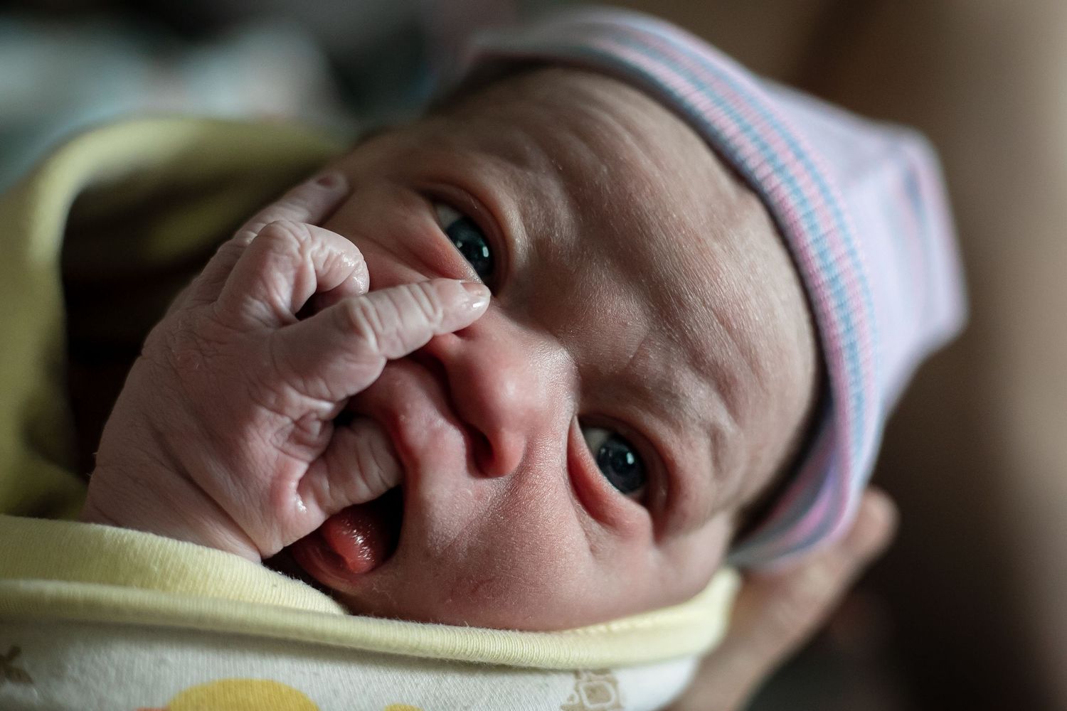 Newborn Baby held by grandma in his home near Sioux City, IA.