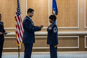 Military members gather for an awards or recognition event in a decorated banquet hall.