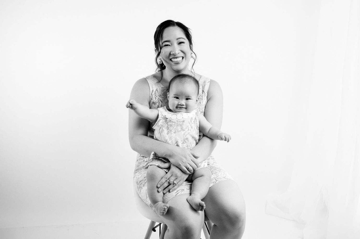 Happy moments between children captured against white studio background.