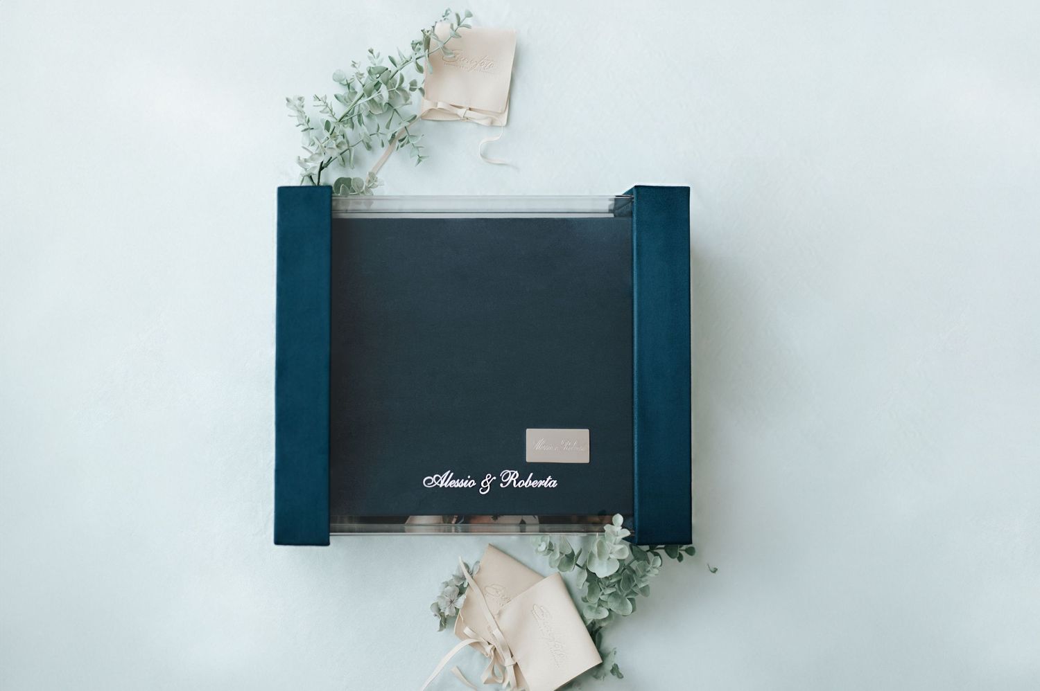 Teal velvet wedding photo box personalized with couple names on a light blue background.