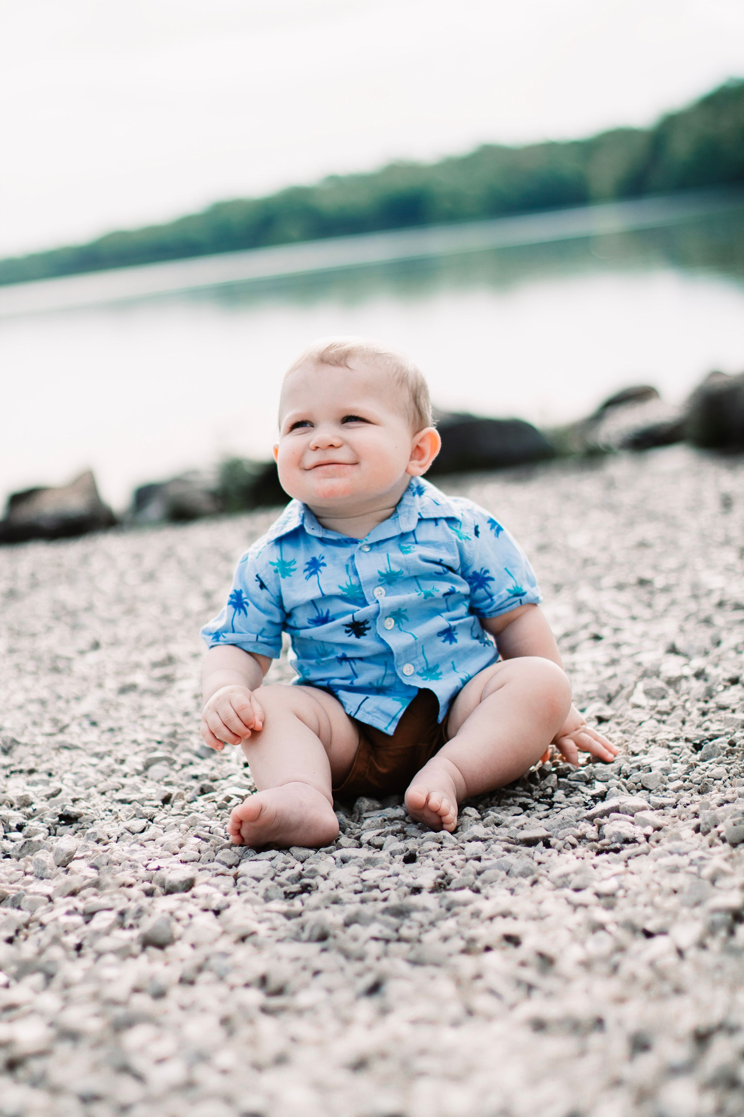 baby boy lake rocks blue happy