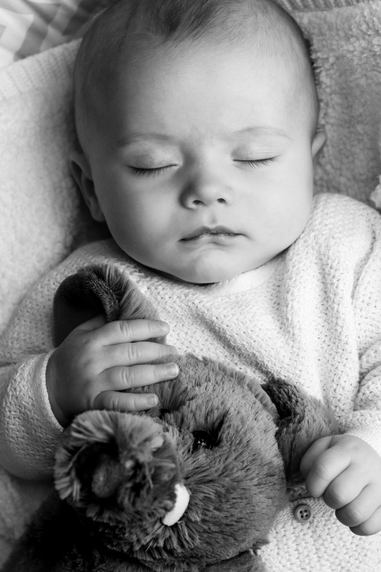 Newborn baby with cuddly toy at home in Epsom, Surrey