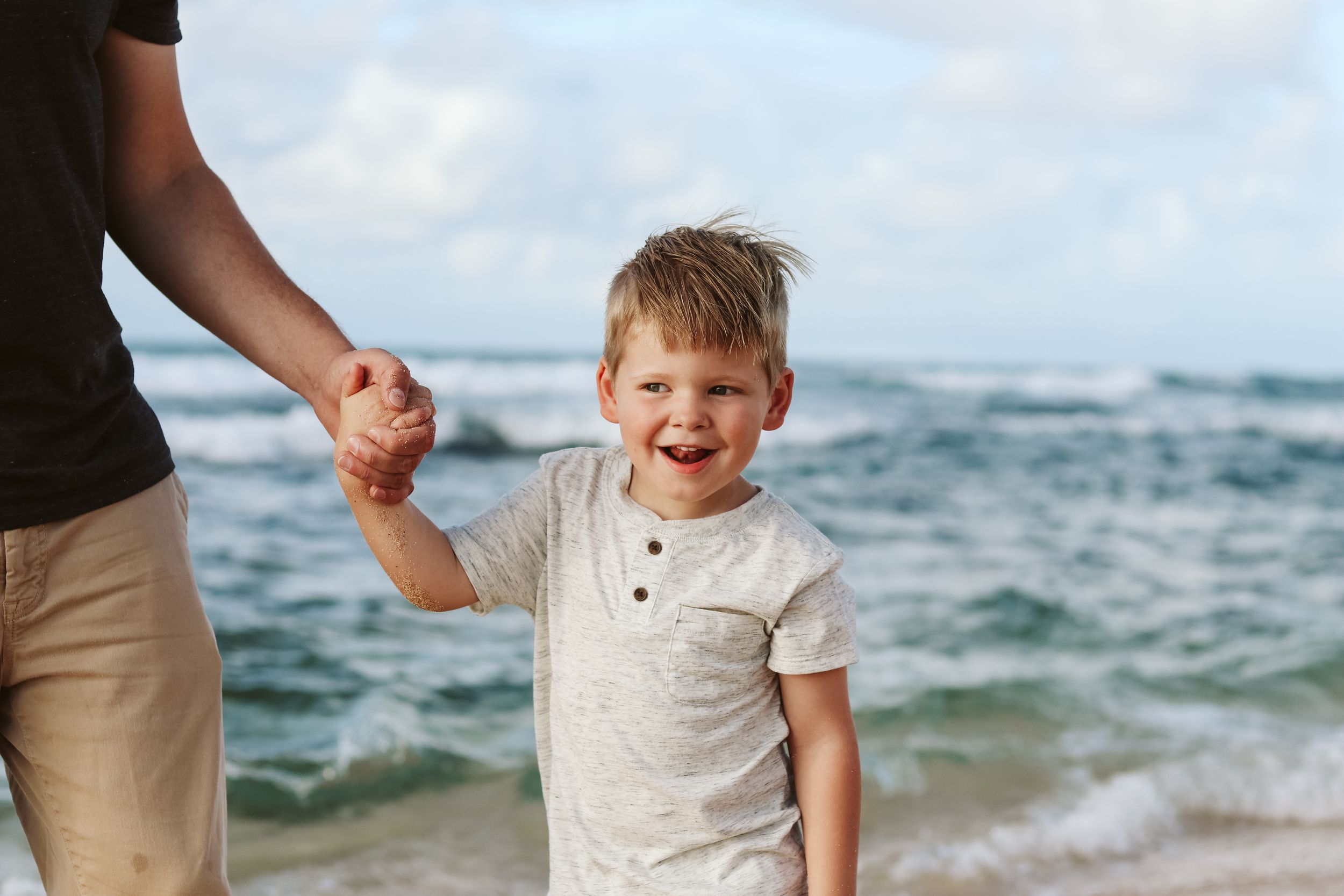 Joyful interactions between family members at a scenic beach setting.