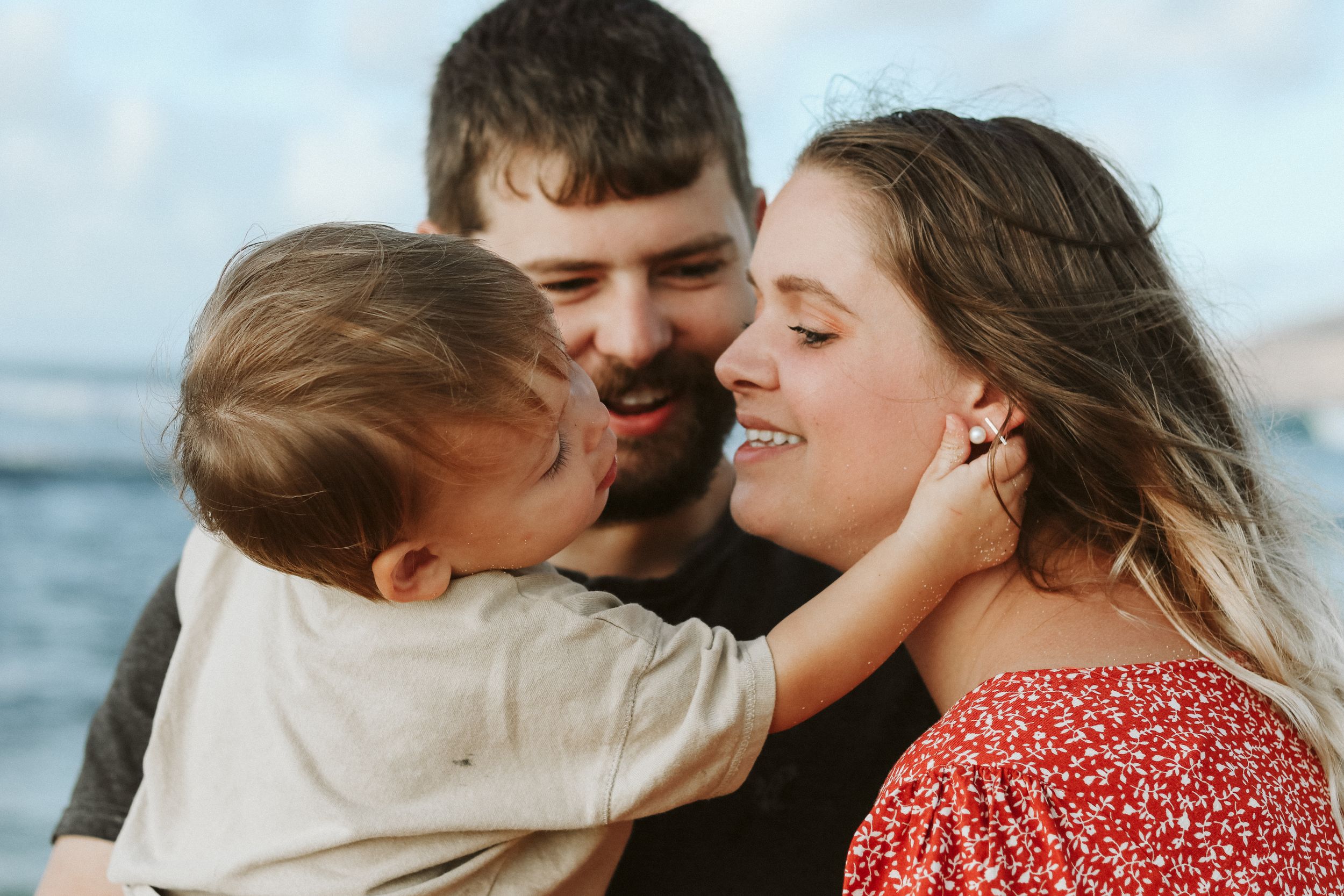 Intimate family moments shared on a beautiful oceanfront beach.