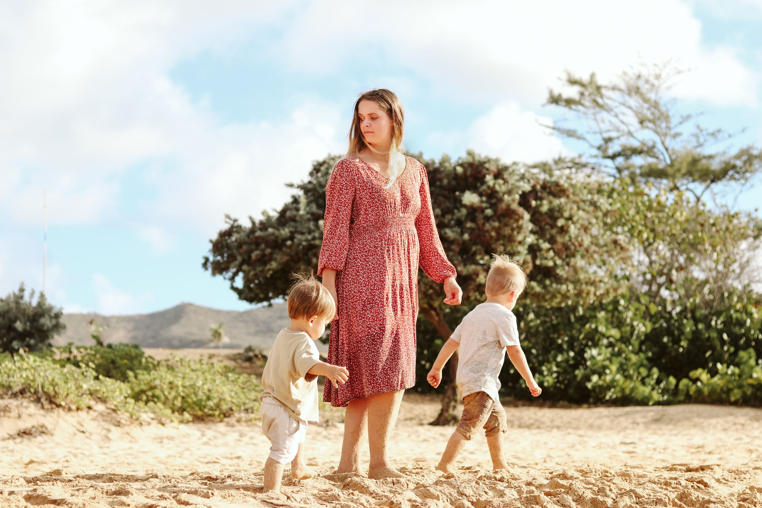 Family enjoying a sunny day together on a scenic mountain trail.