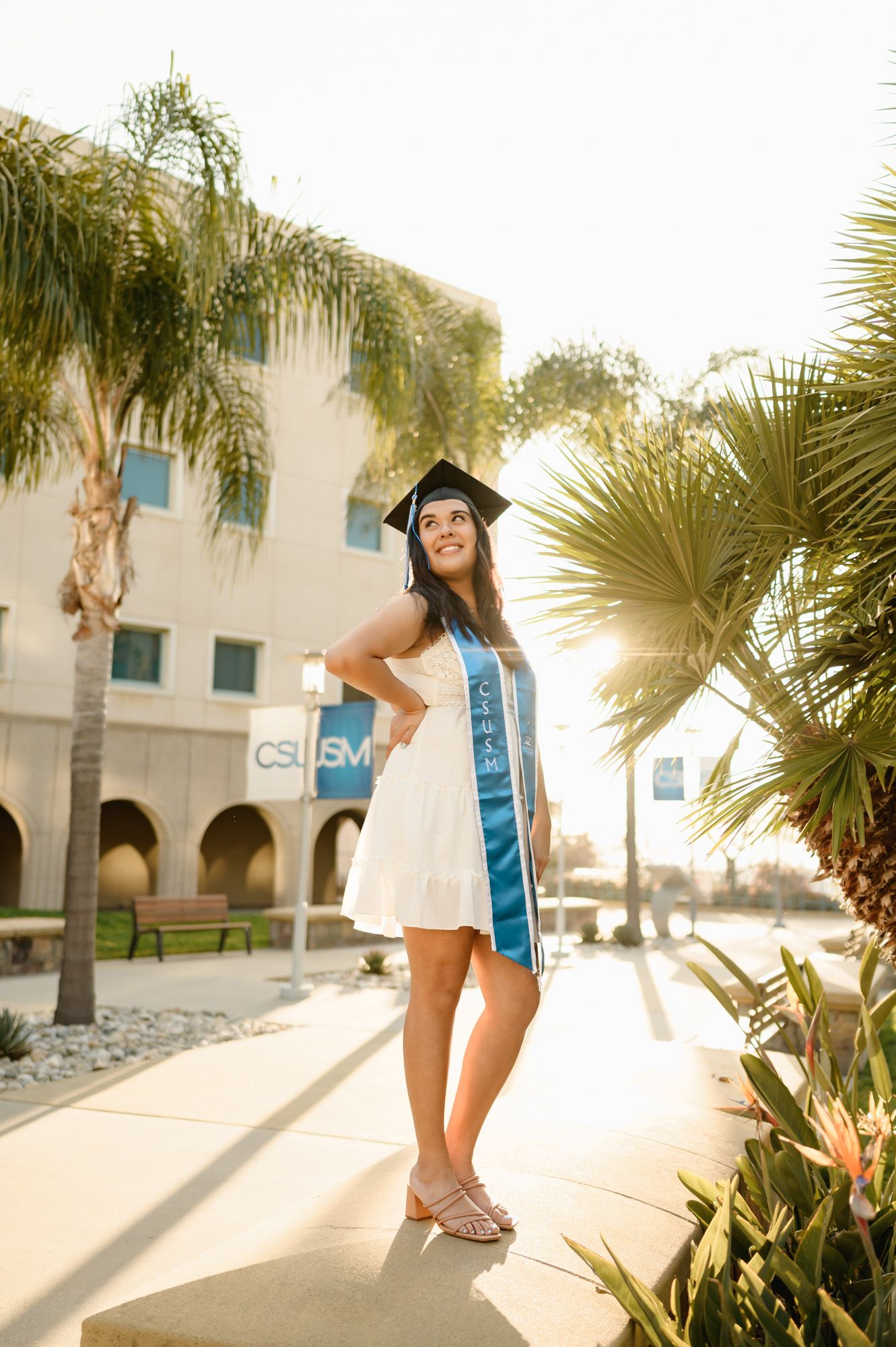 CSUSM grad portraits by Ventura grad photographer of woman in sunlight on campus CSUCI