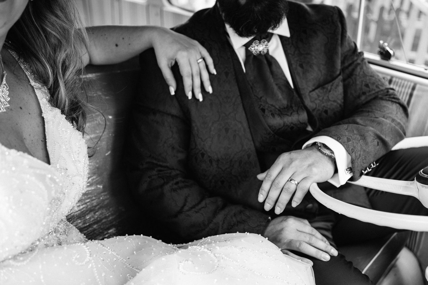 A collection of black and white wedding reception photos showing details of formal attire and table settings.