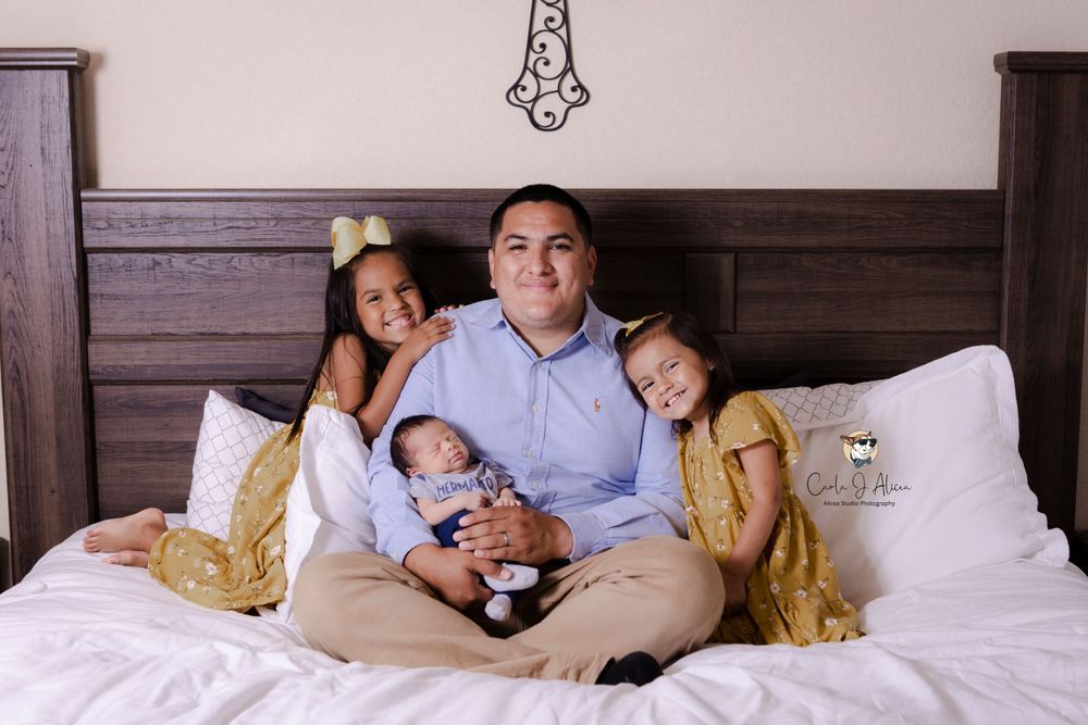 Sweet family portrait showing close bonds as they relax together on bed.