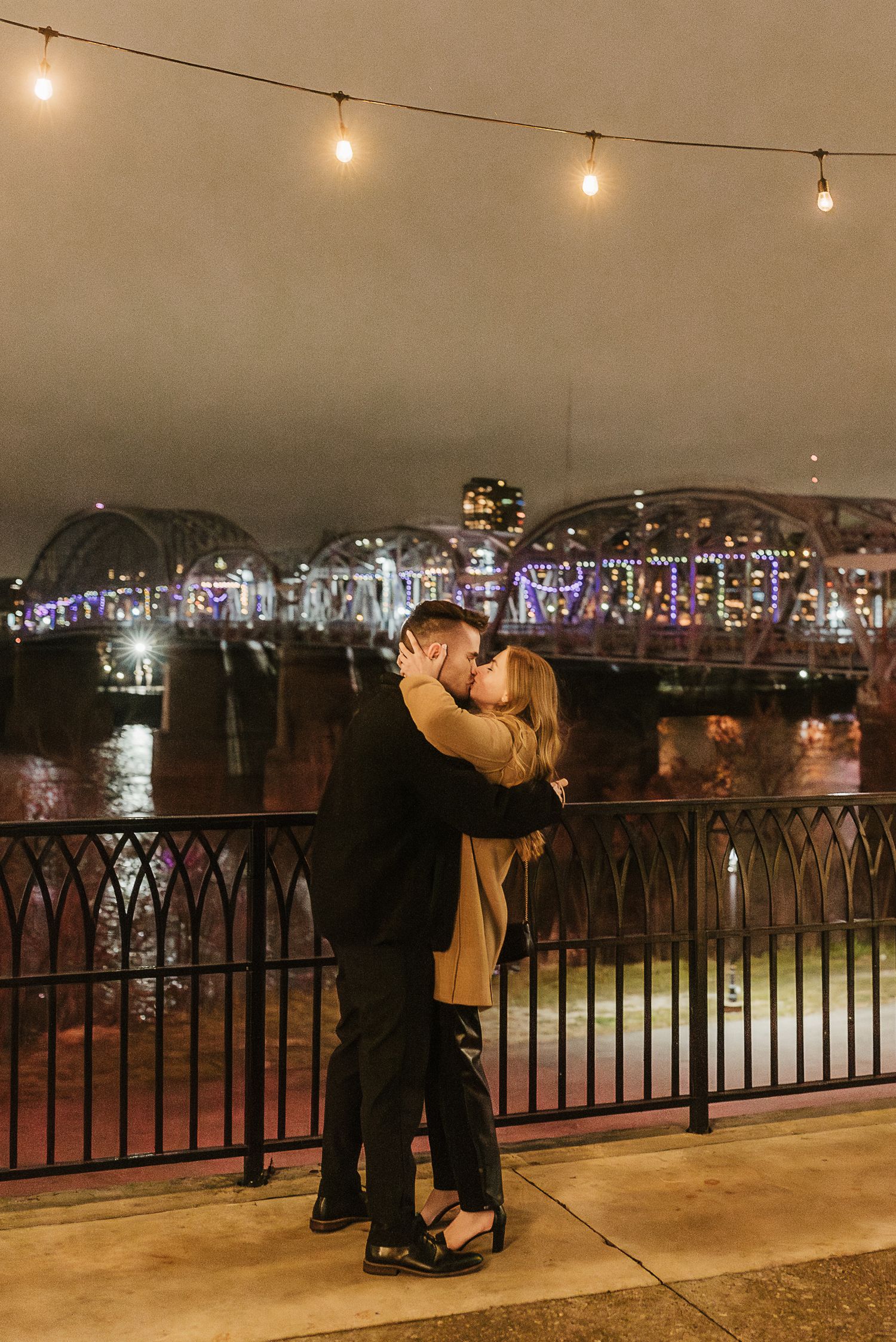 couple celebrates engagement in downtown cincinnati at night