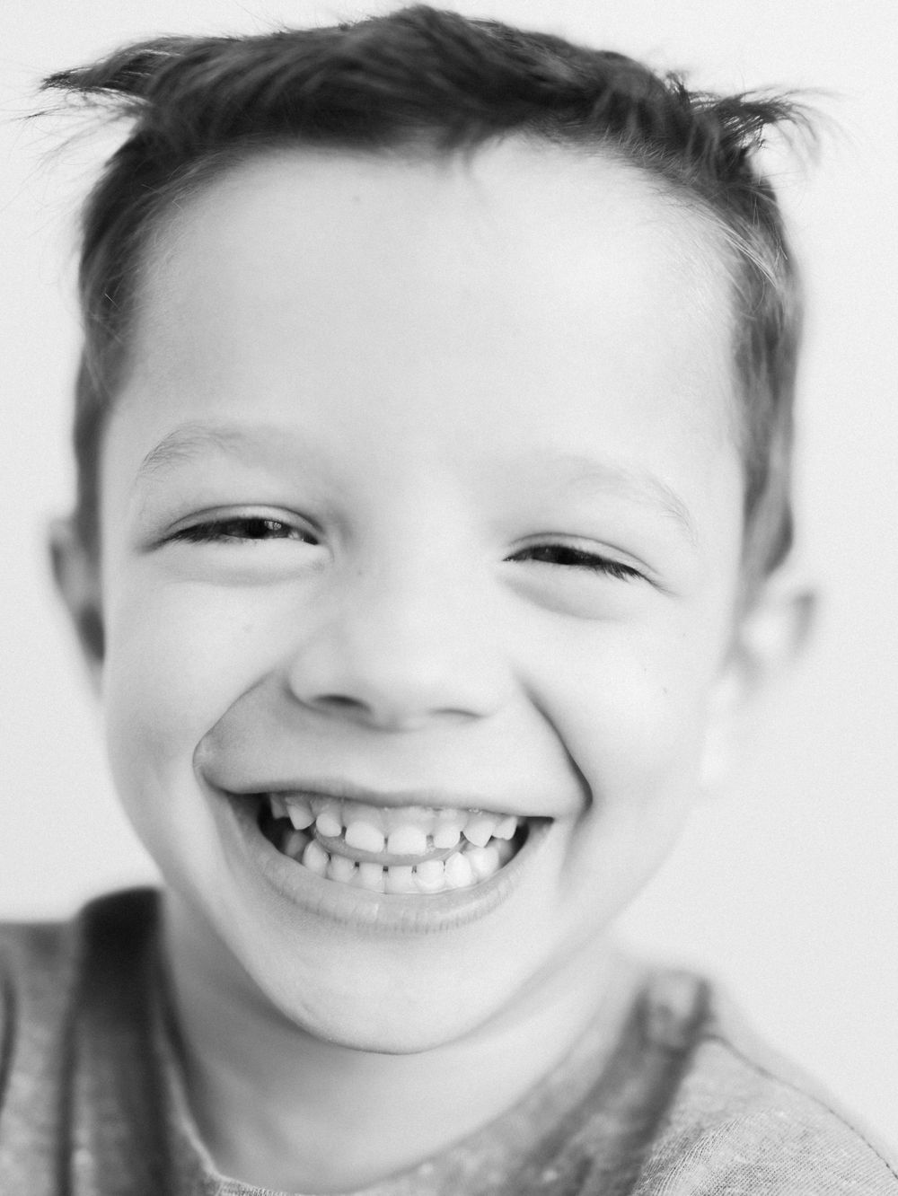 Black and white portrait sequence showing bright genuine smiles and joy.