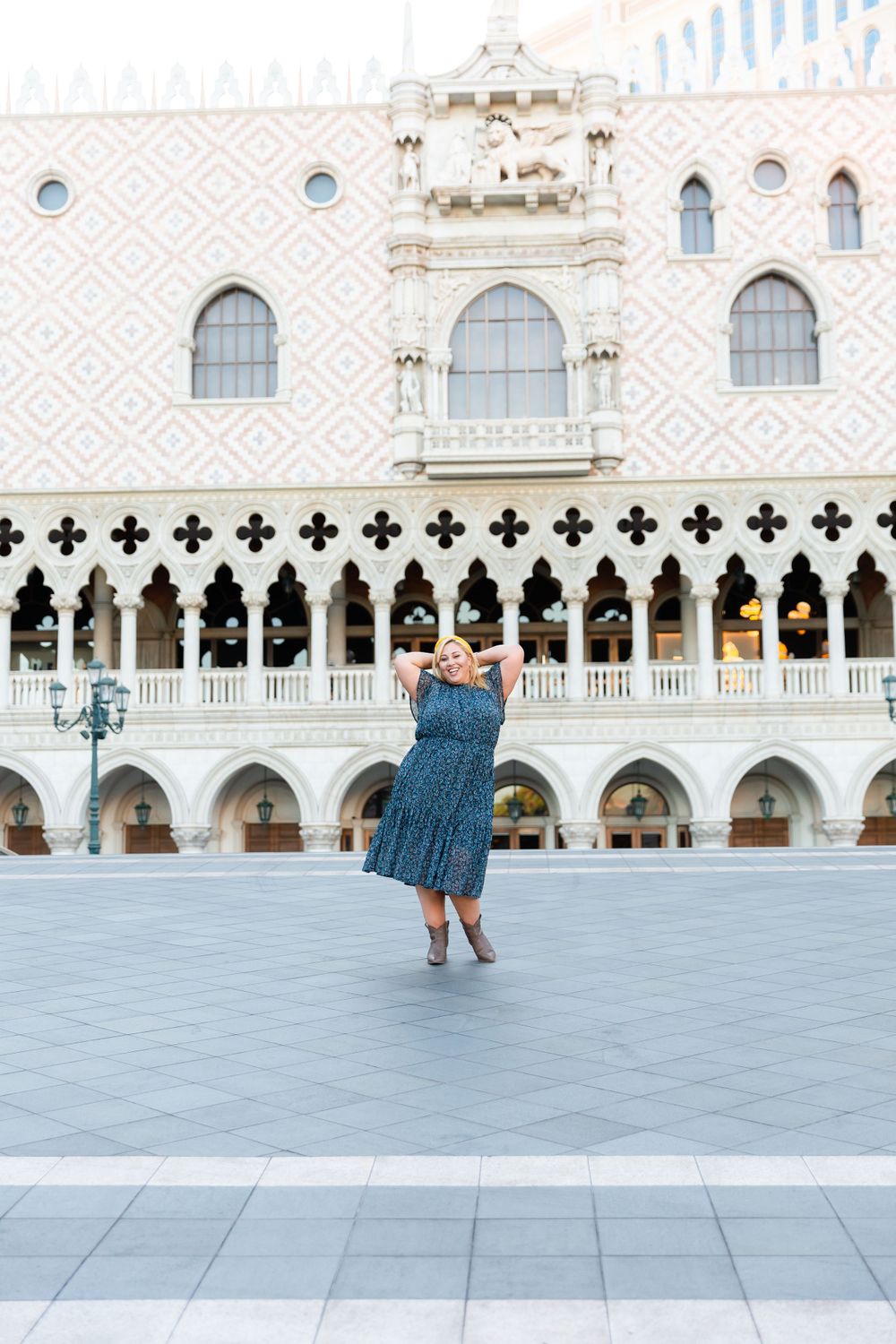 Blue dress creates striking contrast against the white Gothic arches of The Venetian's facade.