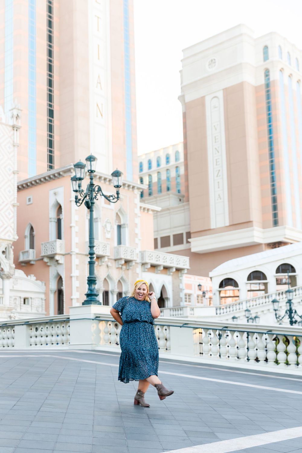 Graceful dance move captured against the stunning Venetian-inspired architecture and ornate lamp posts.
