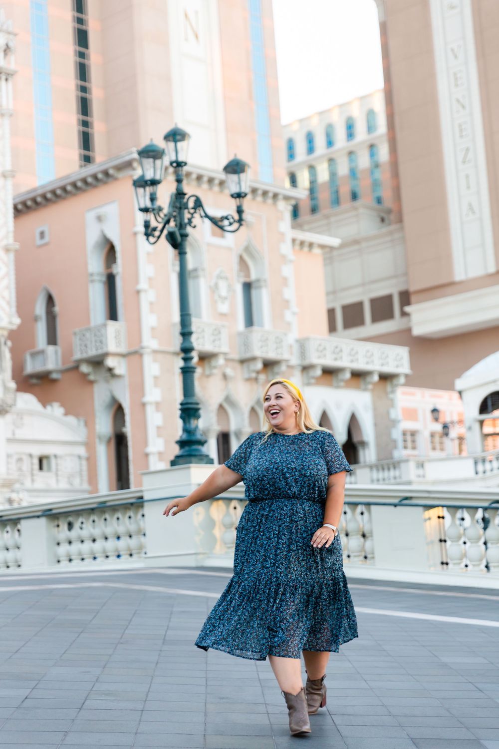 Playful pose beside vintage-style street lamps at The Venetian Las Vegas resort.