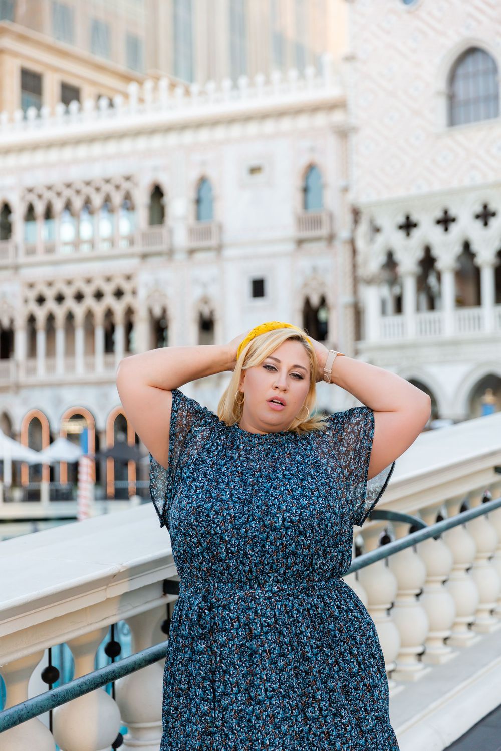 Fashion photo against ornate Venetian Gothic architecture and balustrades.