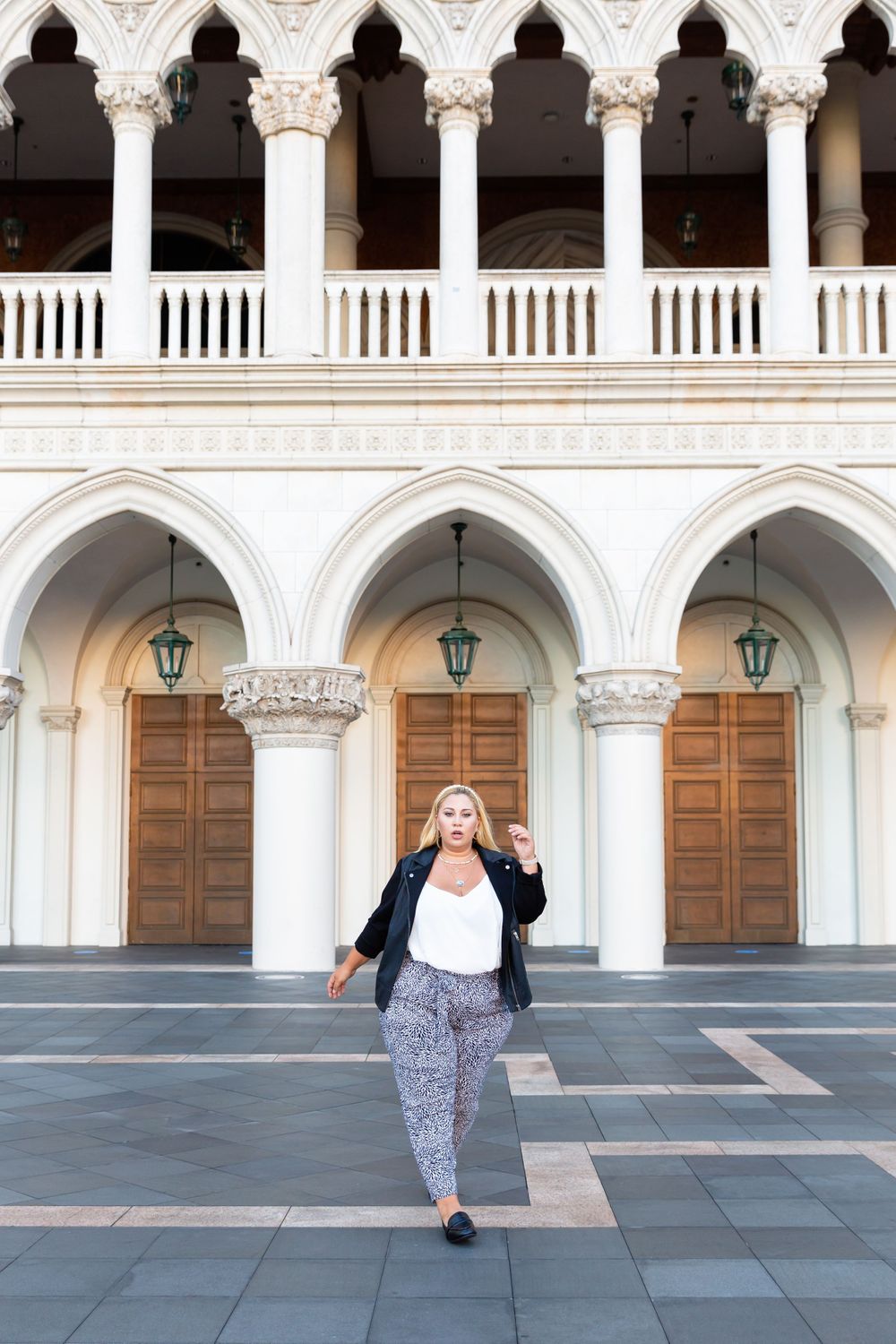 Elegant Gothic colonnade with pointed arches and decorative columns creates stunning architectural backdrop.
