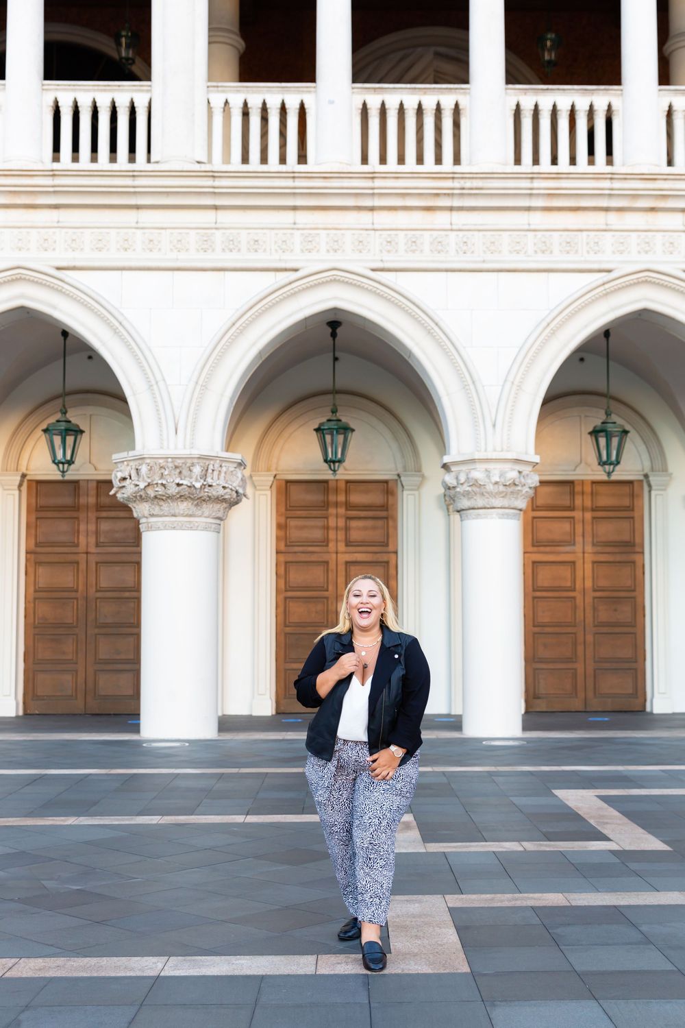 Historic Gothic colonnade features ornate architectural details and classic wooden doors.