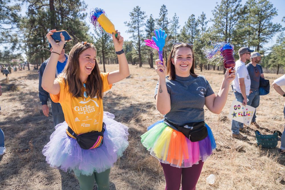 Two girls in Tutus cheering on runners at 2024 Girls on the Run Flagstaff.