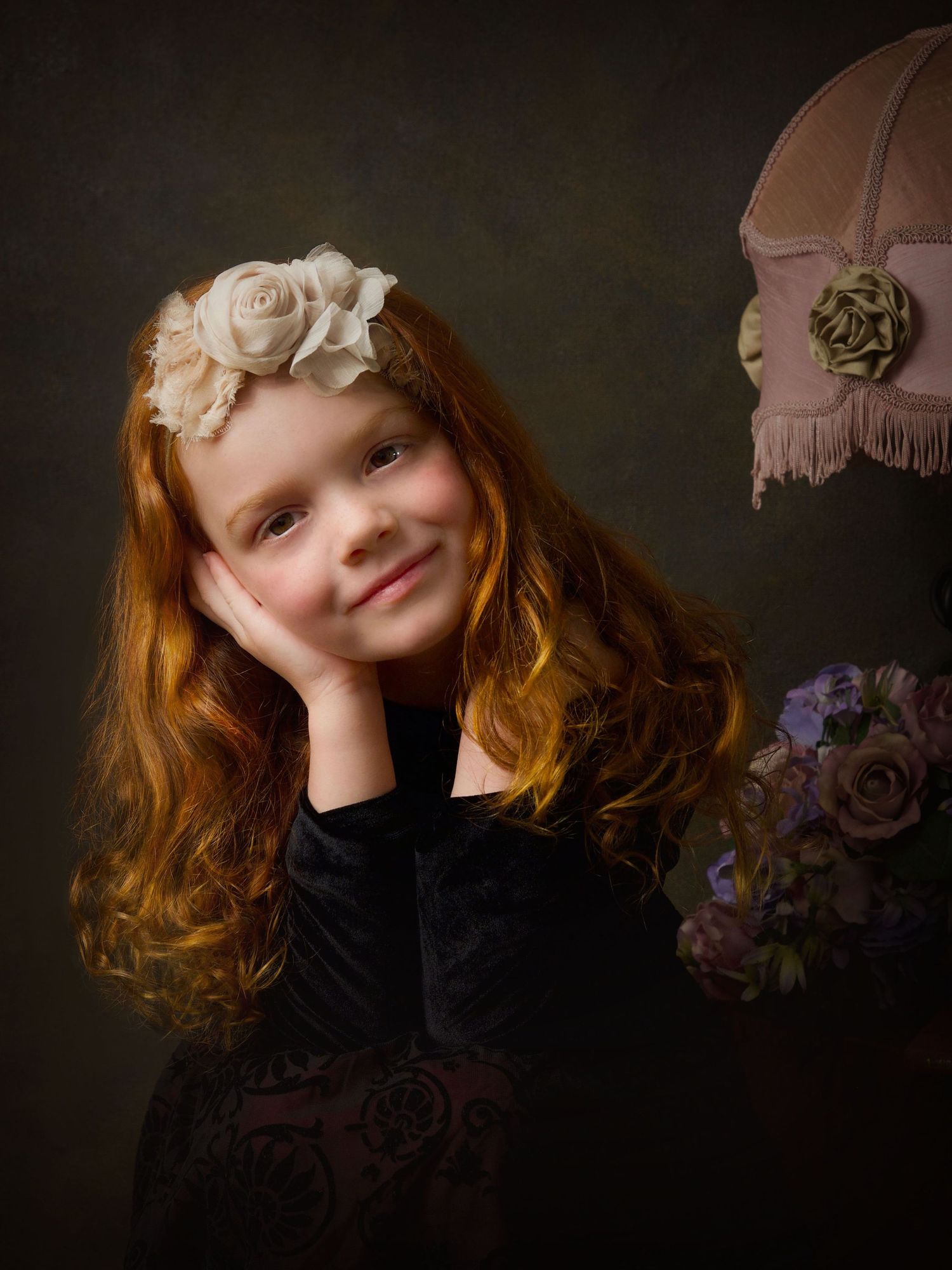 portrait of a young girl with red curly hair brown eyes with angelic smile