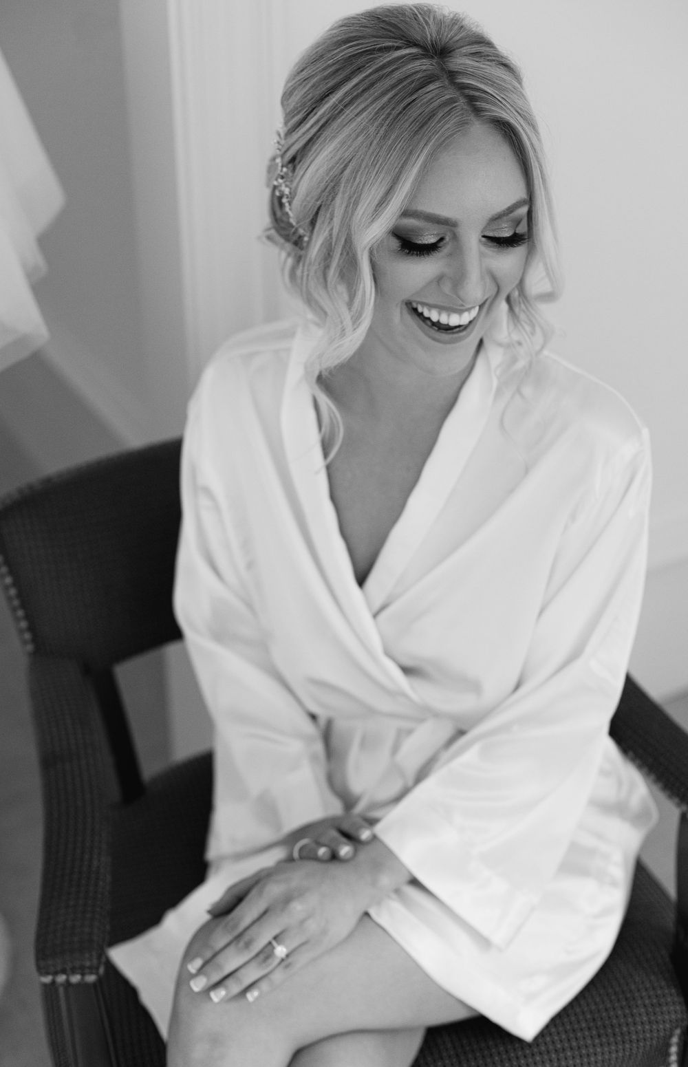Elegant bridal preparation moment captured in black and white photography.