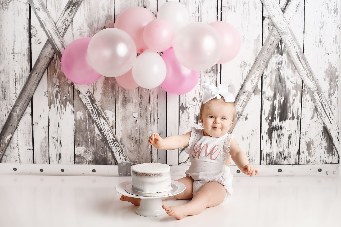 Birthday session with a barnwood door backdrop