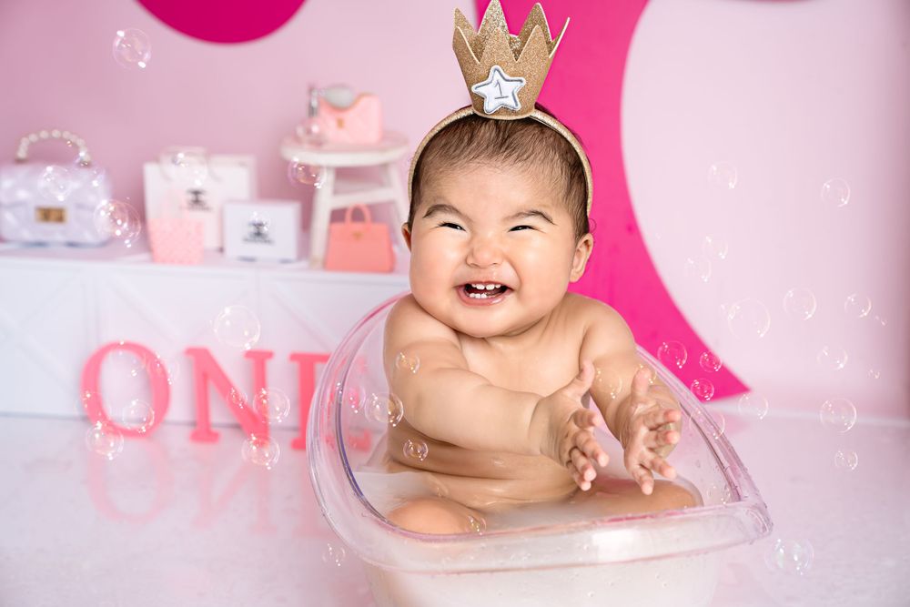 Pink birthday setup with crown decoration and festive party elements.