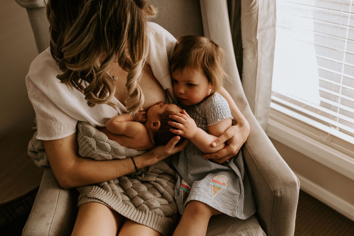 Lifestyle family photography session featuring natural interactions in a bright indoor setting.