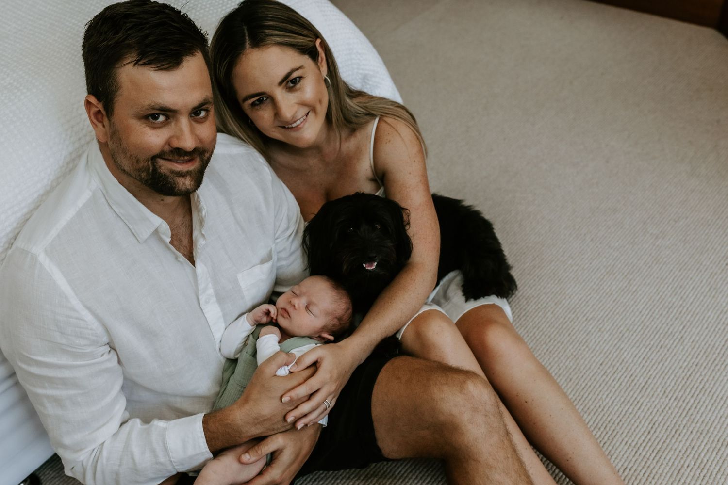 Family shares tender moments together during in-home lifestyle photography session.