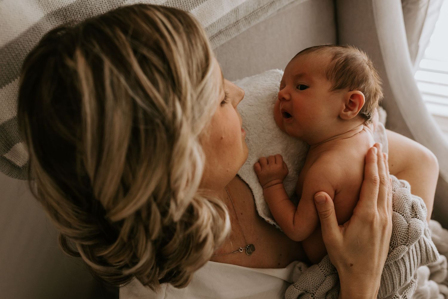 Intimate family lifestyle portraits captured in soft, natural window light.