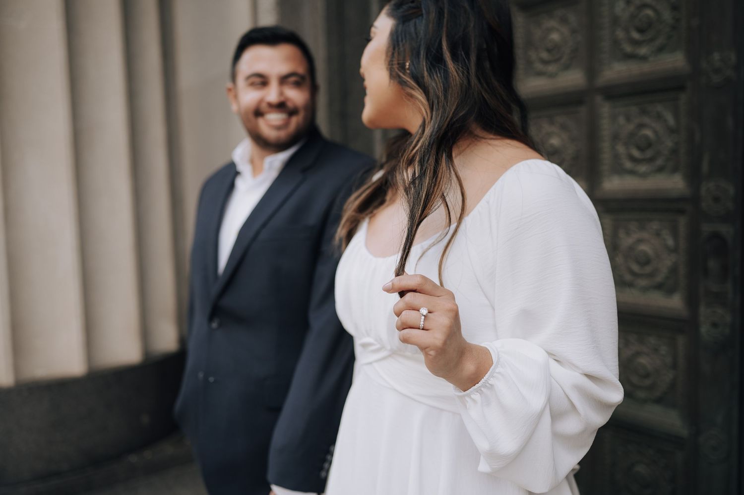 Houston area couple's engagement session. She is wearing white and red-bottom shoes. Huge diamond ring.