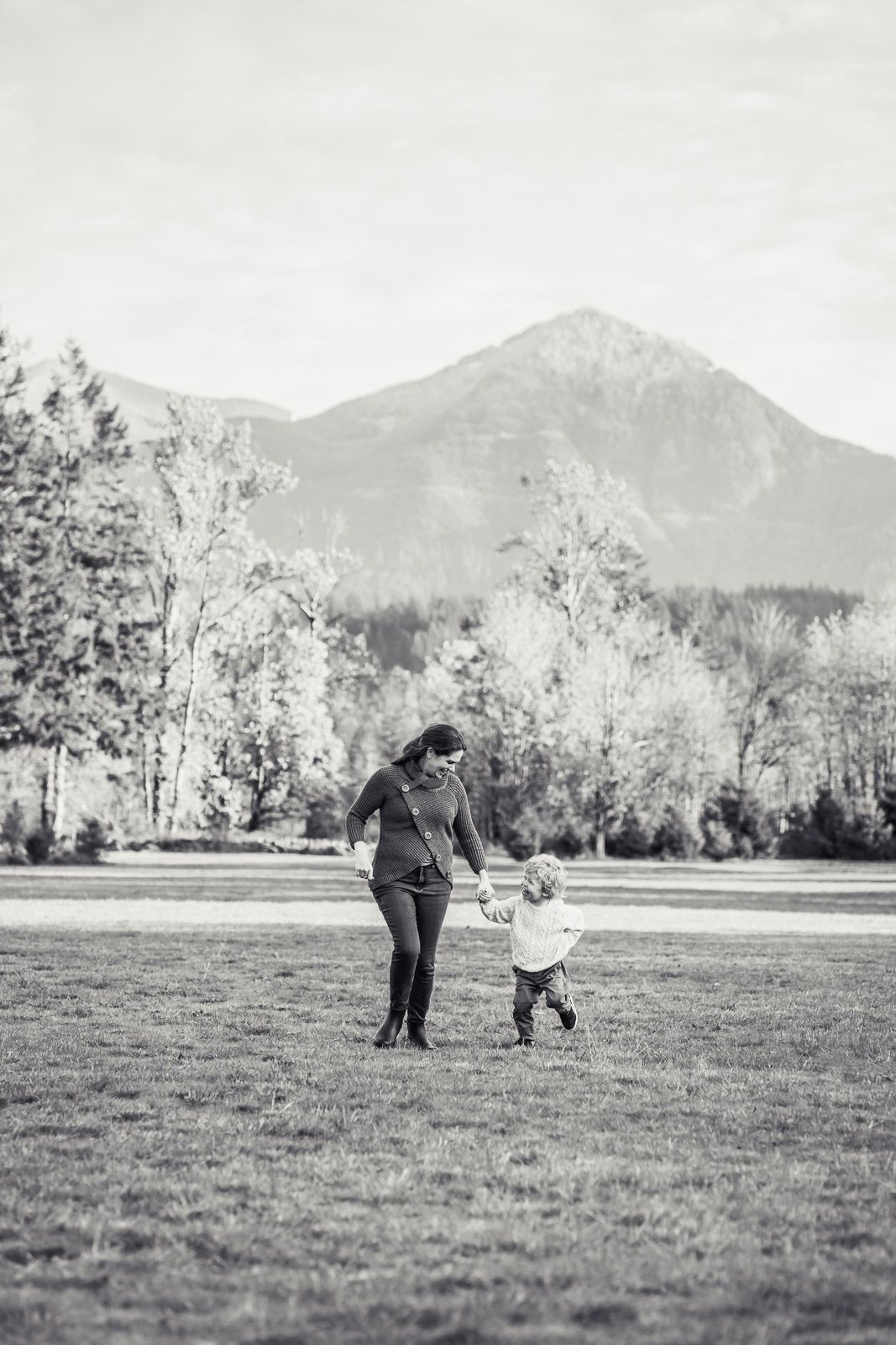 Mother and son running through the field at Tanner Landing Park.