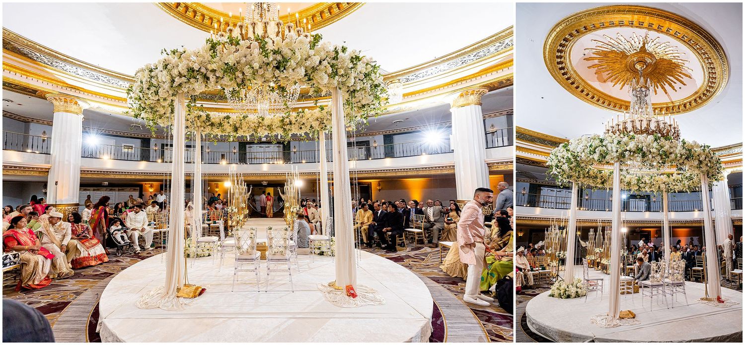 Elegant wedding reception venue featuring ornate crystal chandeliers and circular white floral arrangements.