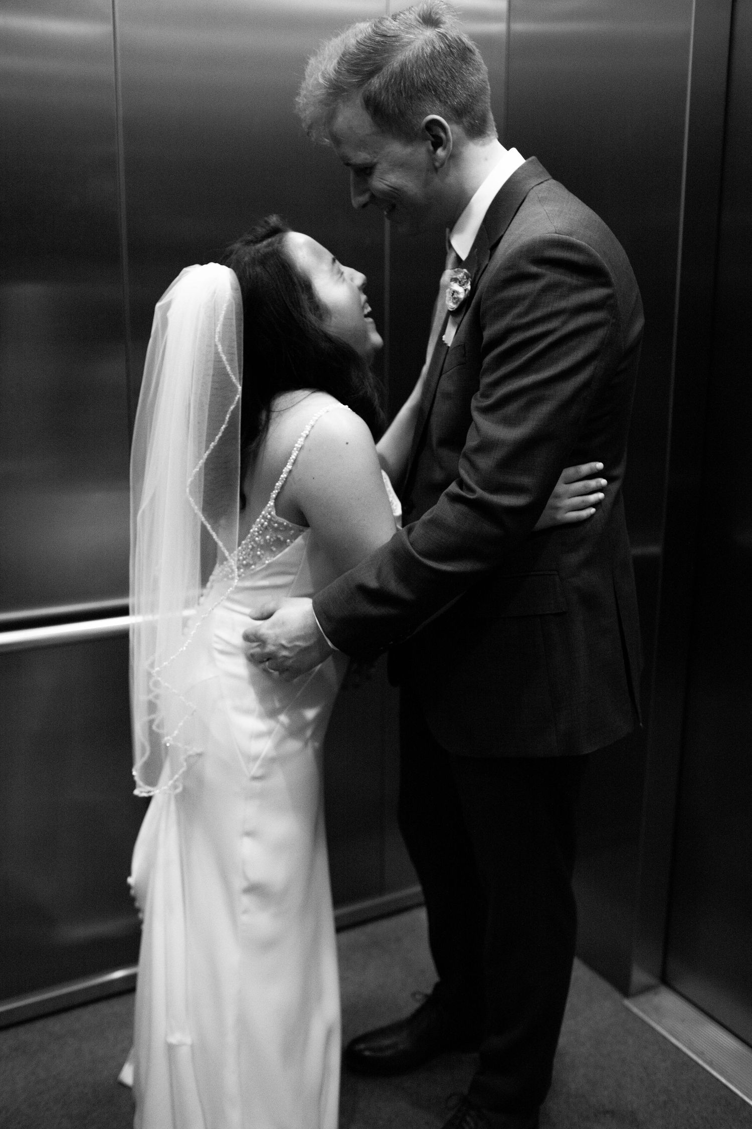 Black and white intimate wedding portrait in an elevator.