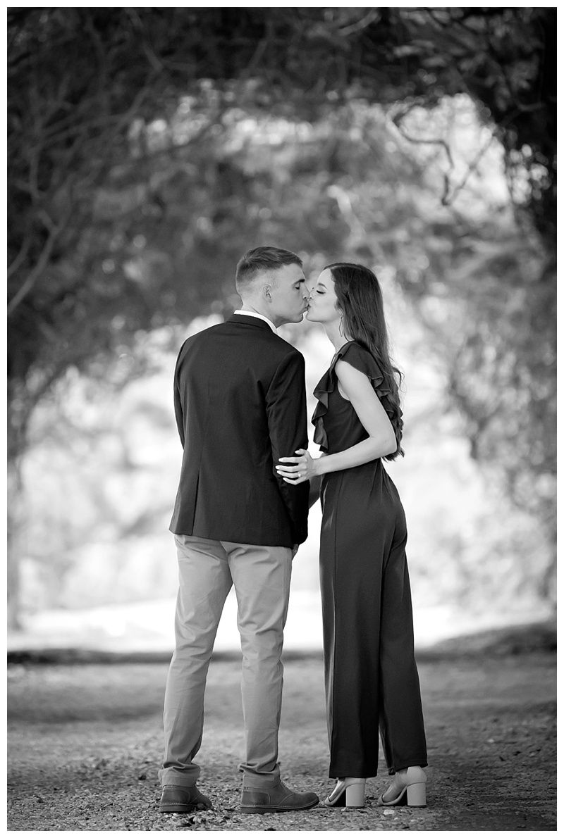 Black and white engagement photos capturing intimate moments outdoors.