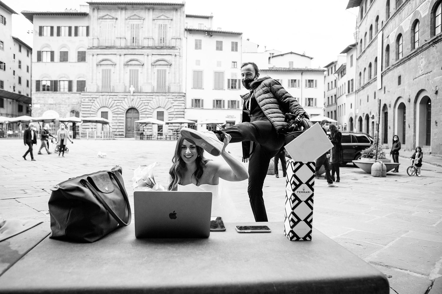 bride with groom showing off his Puma shoes he is wearing for their elopement in Florence