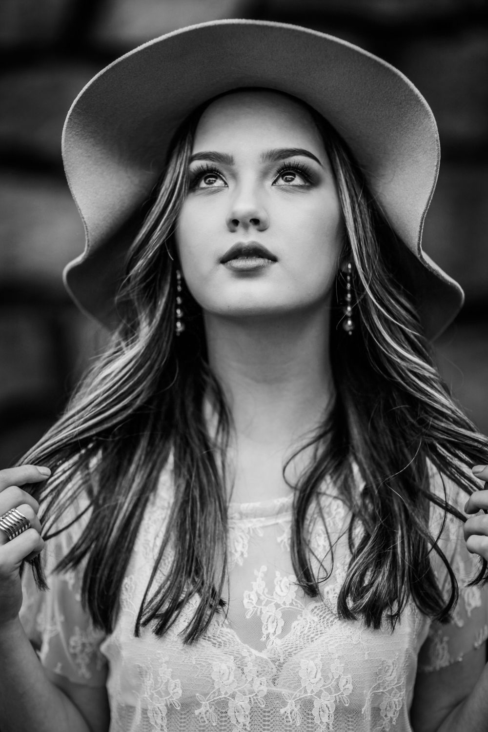 Dramatic black and white portraits featuring wide-brimmed hat and lace details.