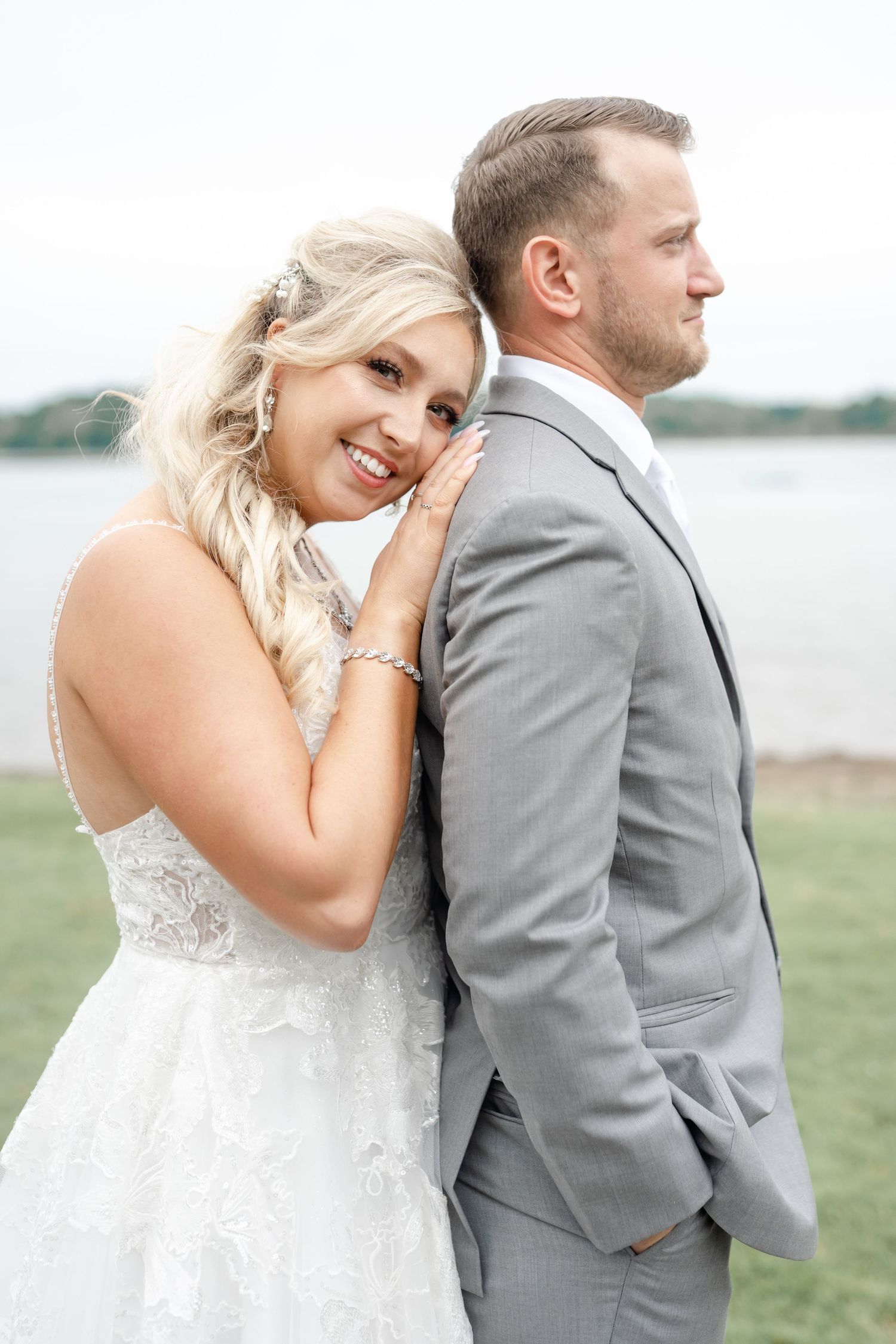 A smiling bride and groom embrace on their wedding day.