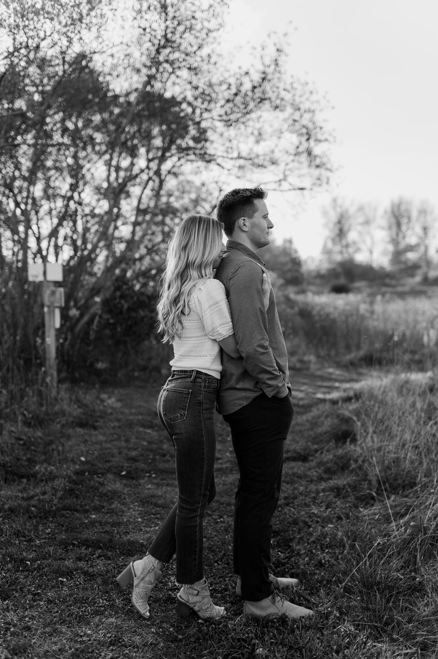A romantic black and white photo series showing a couple embracing in a natural outdoor setting.