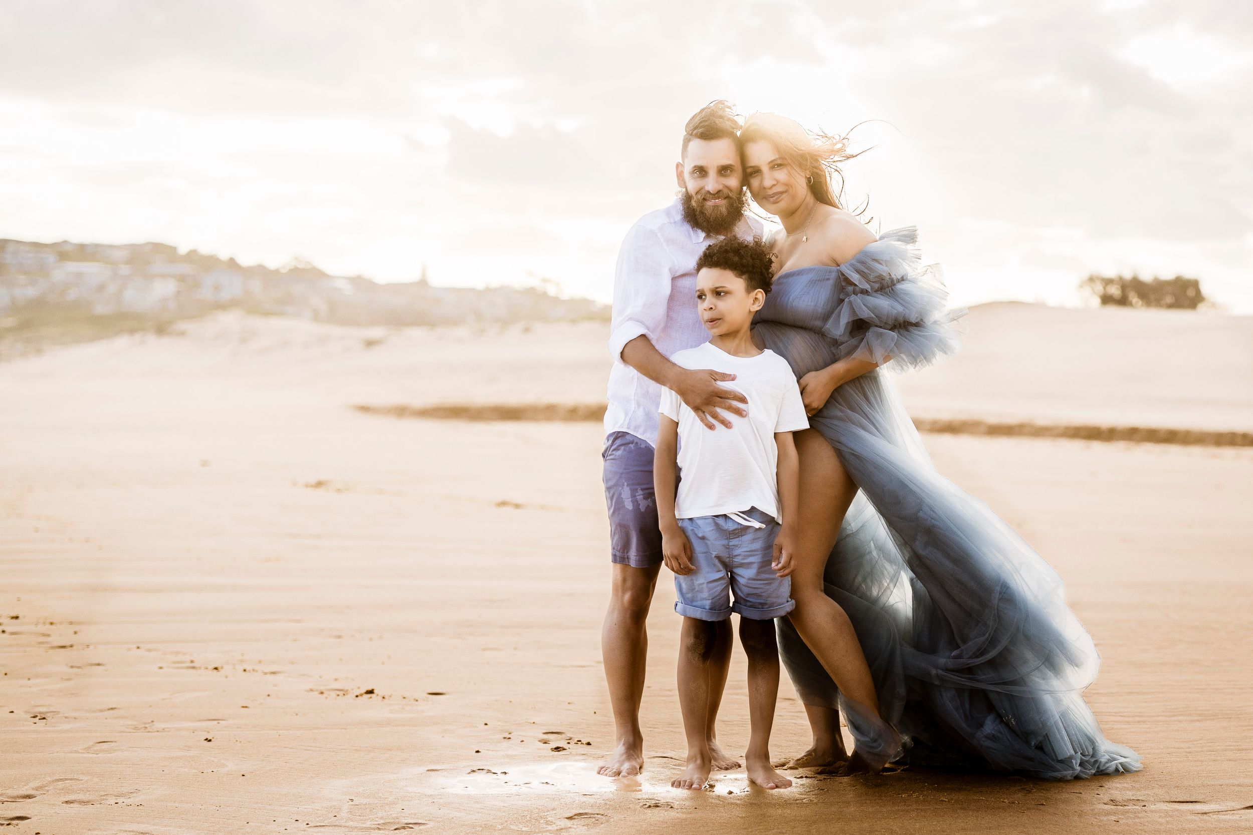 family connection during a sunrise maternity session in DeeWhy Beach