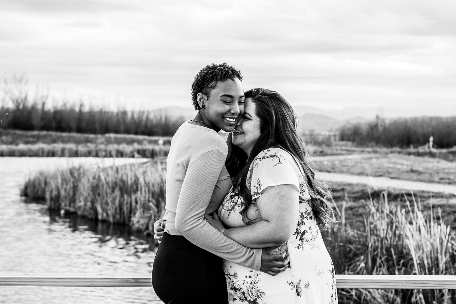 LGBTQIA couple hugging at sunset