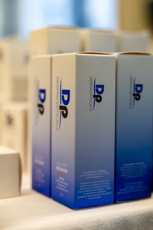 Row of blue and white DP branded product boxes displayed at event.