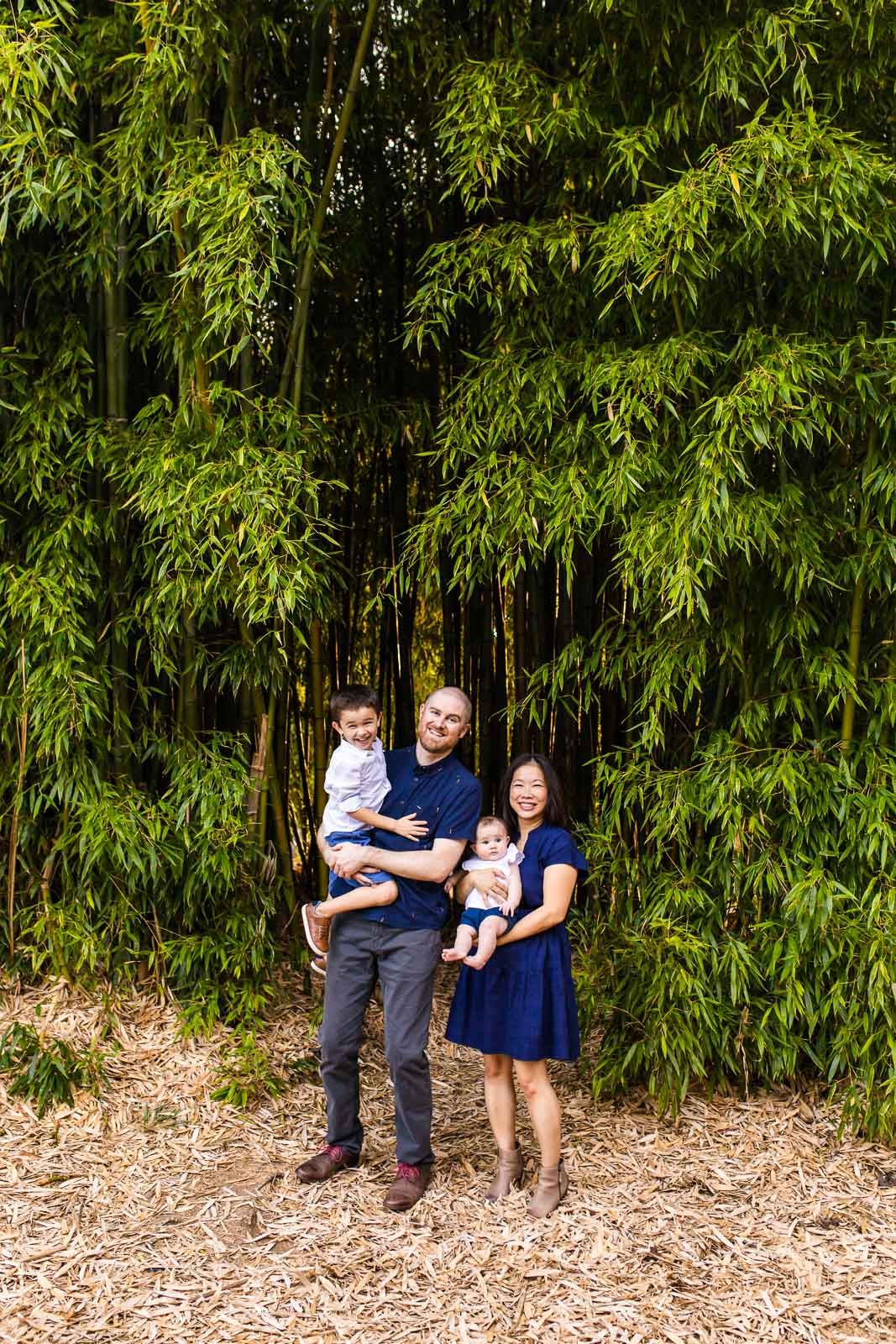 Family posing in front of bamboo trees at McAuliffe Park in Kirkland