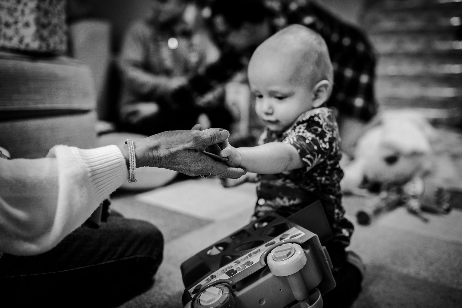 black and white photo of little boy holding his great-grandmothers hand